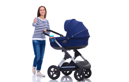 Full length portrait of a mother with a stroller, isolated on white backgroundの写真素材