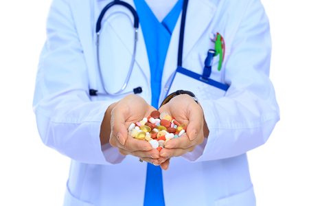 Doctor holding heap of drugs in a handの写真素材