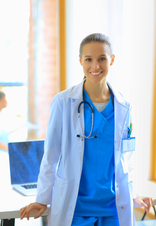 Woman doctor standing at hospitalの写真素材