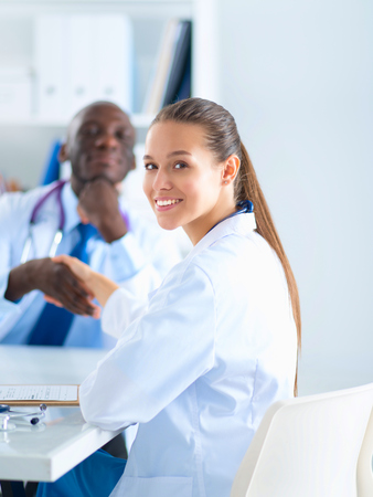 Two happy smiling young medical people handshaking at officeの写真素材