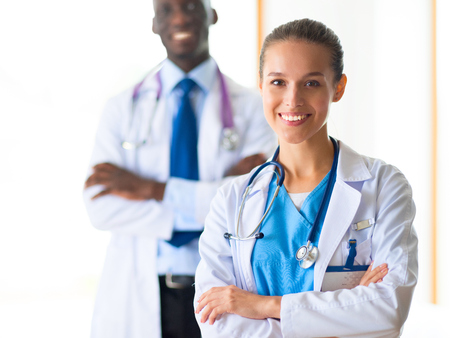 A medical team of doctors, man and woman, isolated on white backgroundの写真素材