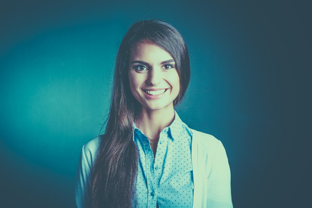 Portrait of a businesswoman , against dark backgroundの写真素材