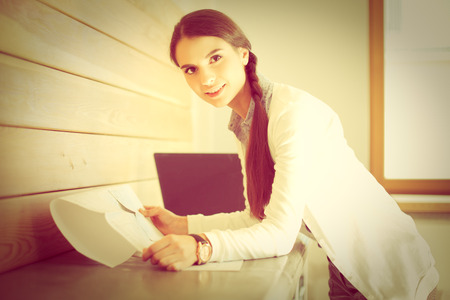 Young female standing near deskの写真素材