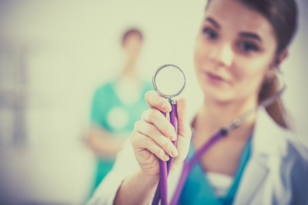 A female doctor with a stethoscope listeningの写真素材