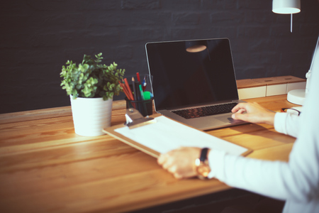 Young female working sitting at a deskの写真素材