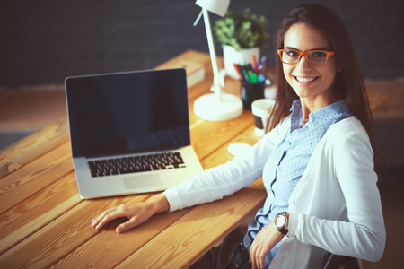 Young female working sitting at a deskの写真素材