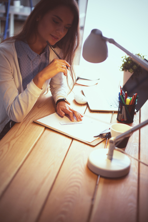 Young female working sitting at a deskの写真素材