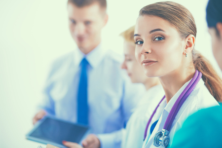 Attractive female doctor in front of medical group.の写真素材