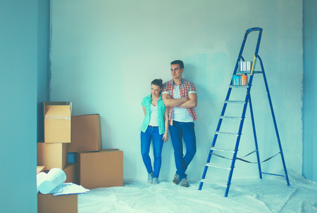 Portrait of young couple moving in new home.の写真素材