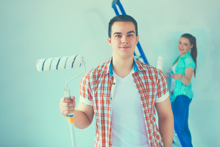 Portrait of young couple moving in new home.の写真素材