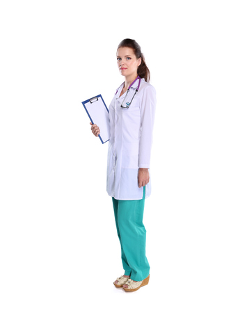 Smiling female doctor with a folder in uniform standing at hospital.の写真素材