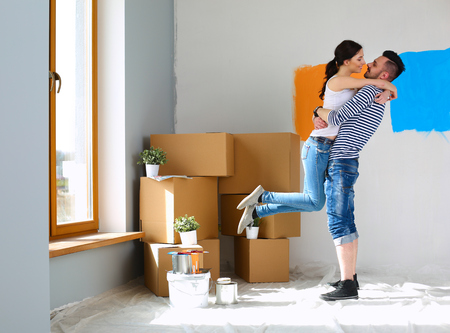 Happy young couple moving in new house.の写真素材