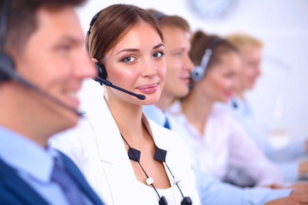 Smiling positive young businesspeople and colleagues in a call center office.の写真素材