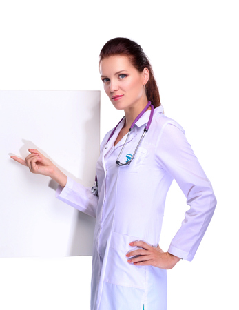 Smiling female doctor with a folder in uniform standing at hospital.の写真素材