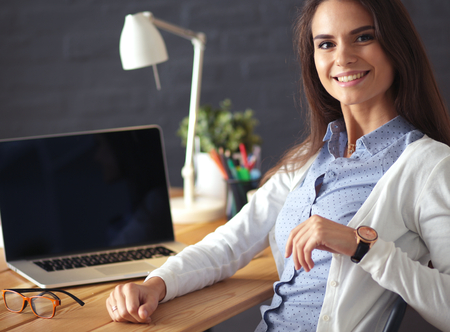 Young female working sitting at a deskの写真素材