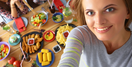 Group of people doing selfie during lunch.の写真素材