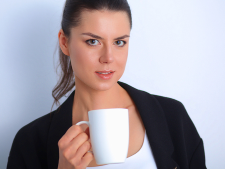 Portrait of young woman with cup tea or coffee.の写真素材