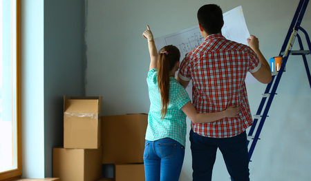 Portrait of young couple moving in new home.の写真素材