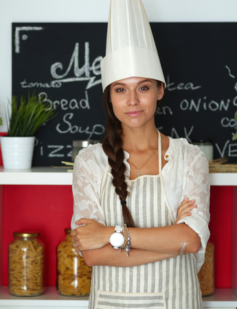 Chef woman portrait with uniform in the kitchenの写真素材