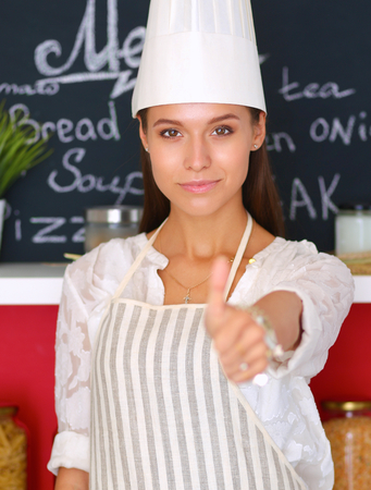 Chef woman portrait with uniform in the kitchen.の写真素材