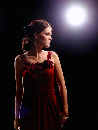 Young woman wearing a red dress standing.の写真素材