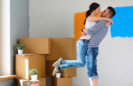 Happy young couple moving in new house.の写真素材