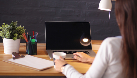 Young female entrepreneur working sitting at a deskの写真素材