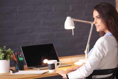 Young female entrepreneur working sitting at a deskの写真素材