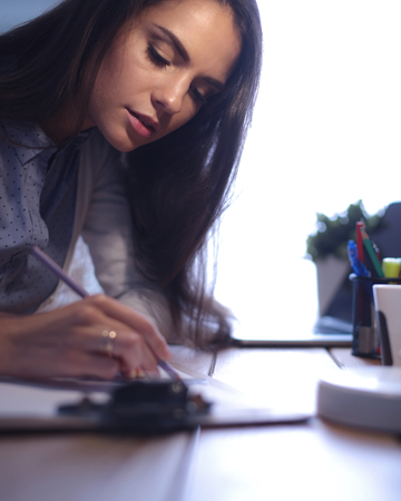 Young female working sitting at a deskの写真素材