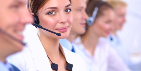 Smiling positive young businesspeople and colleagues in a call center office.の写真素材