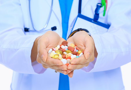 Doctor holding heap of drugs in a handの写真素材