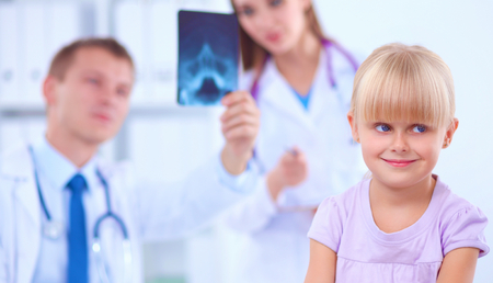Female doctor examining child with stethoscope at surgery.の写真素材