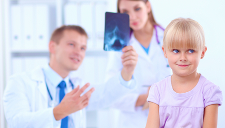 Female doctor examining child with stethoscope at surgery.の写真素材