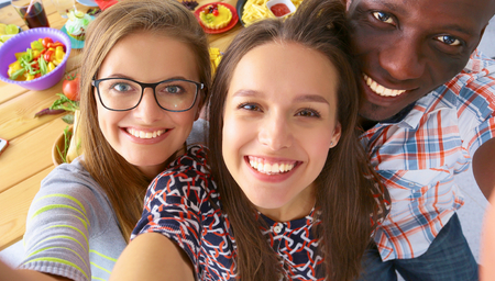 Group of people doing selfie during lunch.の写真素材