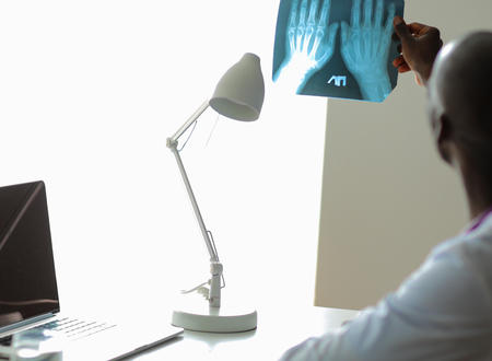 picture of male doctor looking at x-rayの写真素材