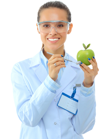 Dentist medical doctor woman hold green fresh apple in hand and mirrorの写真素材