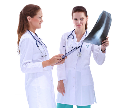 Portrait of two successful female doctors holding a writing pad and x-ray.の写真素材
