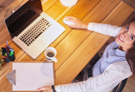 Young female entrepreneur working sitting at a deskの写真素材