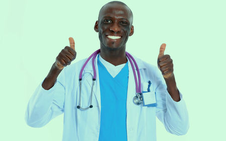 Portrait of doctor showing you ok sign standing in a white uniform on isolated backgroundの写真素材