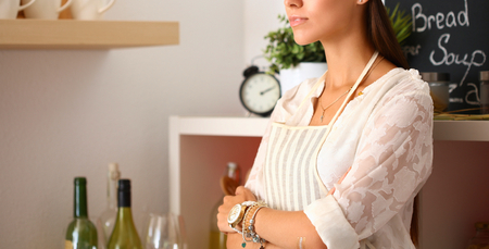 Chef woman portrait with uniform in the kitchenの写真素材
