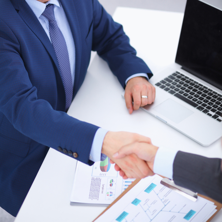 Business people shaking hands, finishing up a meeting, in officeの写真素材