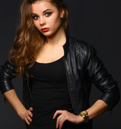 Portrait of beautiful brunette female wearing leather jacketの写真素材
