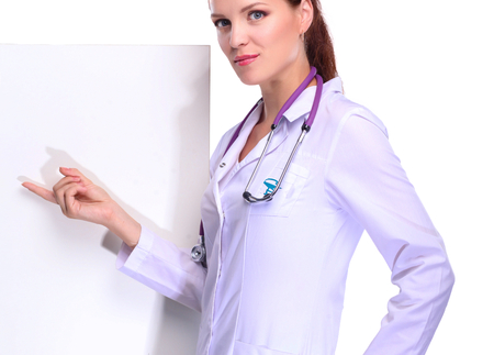 Smiling female doctor with a folder in uniform standing at hospital.の写真素材