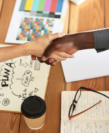 Business people handshake sitting on the desk in office.の写真素材