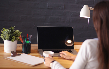 Young female entrepreneur working sitting at a deskの写真素材