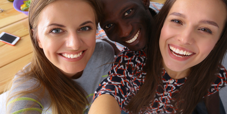 Group of people doing selfie during lunch.の写真素材