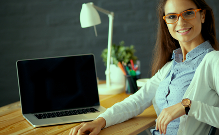 Young female working sitting at a deskの写真素材