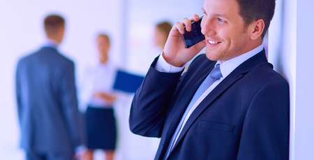 Business man using his mobile phone in office.の写真素材