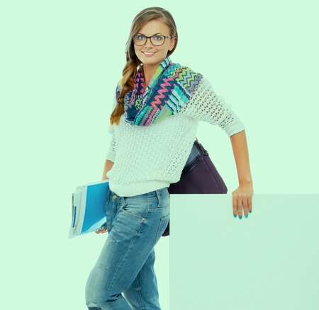 Beautiful student woman pointing on blank board.の写真素材