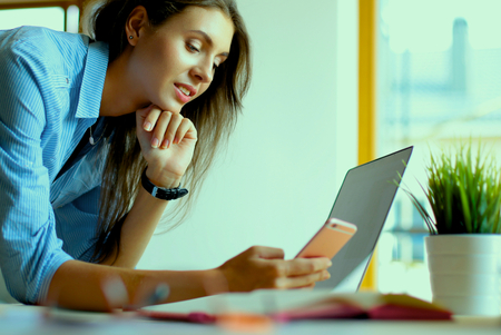 Young female businesswoman in the office near desk.の写真素材